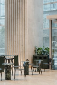 Elegant dining space with a large marble countertop, multiple chairs, and a sophisticated atmosphere