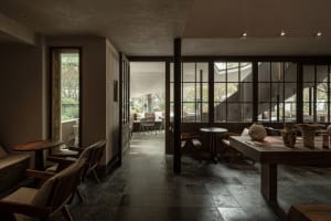 A cozy cafe dining area with several chairs and tables arranged throughout the space, featuring inviting and comfortable seating for enjoying a meal or coffee