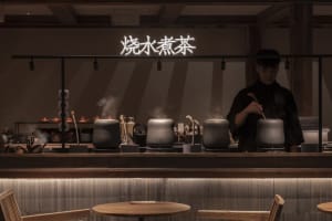 Cozy Asian restaurant with wooden interior, dining table, and counter, featuring traditional Asian cuisine
