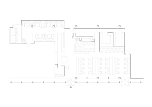 Modern restaurant interior with multiple dining tables, chairs, and a bar, featuring a functional and spacious design