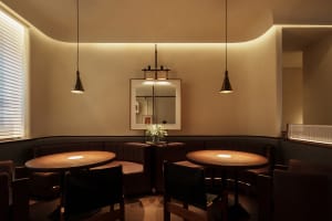 Warm and inviting restaurant interior with wooden tables and chairs, pleasant lighting, and a cozy atmosphere