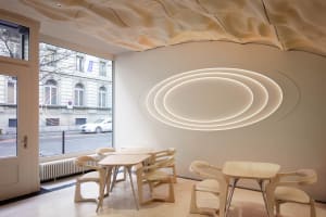 Warm and inviting restaurant interior with wooden tables and chairs, soft diffused lighting, and a cozy atmosphere