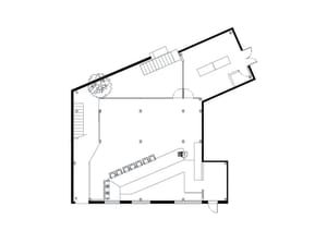 2D floor plan of a modern office space with a staircase, chairs, and clean lines