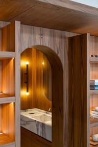 Modern bathroom with a double sink and mirror, illuminated by lights on either side