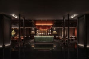 Elegant restaurant interior with a large dining area, tables, chairs, and potted plants