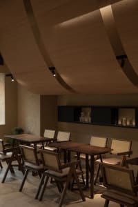 Warm and inviting restaurant interior with wooden tables and chairs, creating a comfortable seating arrangement for guests
