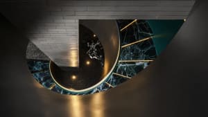A photo of a spiral staircase with a metal railing, set in a modern building with a sophisticated atmosphere