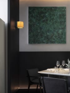 Elegant dining space with a dark wood table and chairs, glassware, and fine china, set in a sophisticated atmosphere