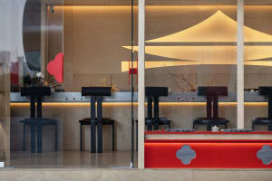 Sleek modern restaurant with wooden walls, tables, and chairs, warm and inviting atmosphere, soft lighting