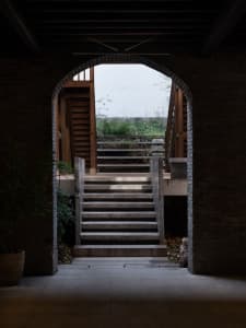 A stone staircase in an old building with natural light illuminating the scene