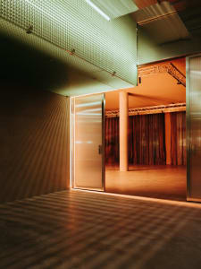 Empty modern room with a glass doorway, metal frame, and minimalist design