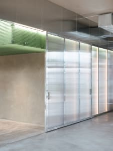 A clean and well-organized hallway with metal walls, multiple doors, and a focus on functionality and efficiency