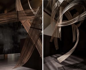 A room with a large wooden structure composed of multiple pieces of wood and smaller wooden elements, showcasing a creative and unique design approach
