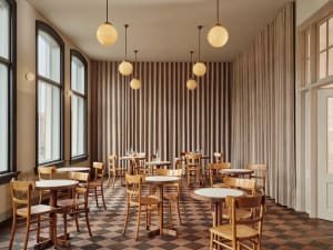 An empty restaurant with wooden tables and chairs, dimly lit for a relaxing ambiance