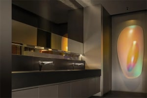 Modern kitchen design featuring two sinks on a black marble countertop with a minimalist and contemporary style