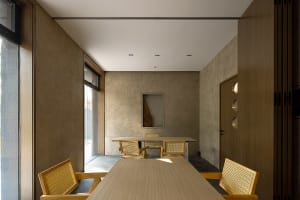 A modern dining area with a wooden table and chairs, surrounded by a clean and minimalist space