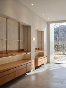 Well-lit kitchen with wooden cabinets, two sinks, and ample storage options