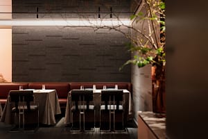 A well-lit restaurant interior with multiple tables and chairs, creating an elegant and inviting atmosphere