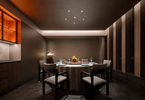 A round dining table set for dinner service in a modern restaurant with clean lines and minimalist decoration