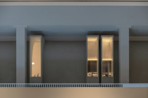 Empty room with two large windows on opposite walls, allowing natural light to enter and creating a bright atmosphere