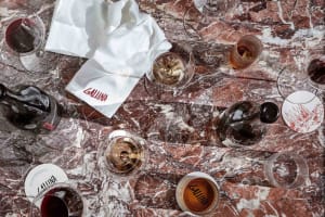 A marble tabletop with wine glasses and a bottle, set in an elegant and sophisticated atmosphere