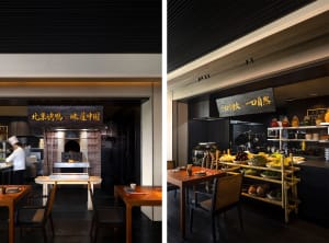 Warm and inviting restaurant interior with brick walls, a fireplace, and industrial kitchen with dining tables, chairs, and various tableware
