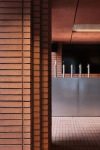 A casual bar area with a brick wall, featuring multiple beer taps and a rustic atmosphere