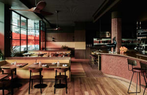 Warm and inviting restaurant interior with wooden floors, tables, chairs, and decorative elements, creating a comfortable dining atmosphere