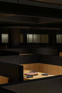 Office space with wooden walls and floors, multiple desks and chairs, and a professional atmosphere