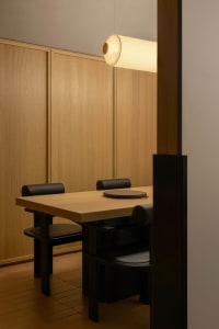 A warm and inviting dining space with a wooden table and chairs, surrounded by a cozy atmosphere