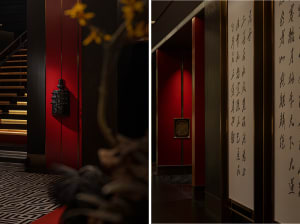A modern hallway with red walls, a black vase, and a floor plan layout including doors and windows