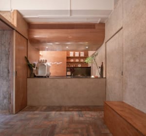 Warm and inviting kitchen space with wooden floors, cabinets, and countertops, featuring potted plants and a cozy atmosphere