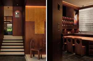 Modern restaurant interior with wooden floors and walls, featuring chairs and dining tables, and a warm inviting atmosphere