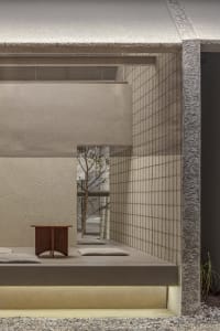 Cozy living space with a wooden table, two couches, and a dining table, creating a warm and inviting atmosphere