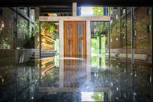 A serene pool area with water reflecting the surroundings, surrounded by a well-lit space