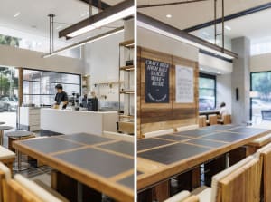 Warm and inviting restaurant interior with wooden elements, tables, chairs, and kitchen appliances