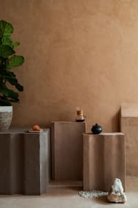 Cozy living area with beige walls, a table with a bowl of food and a vase, and a warm atmosphere