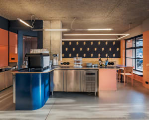 Industrial kitchen with stainless steel appliances, granite countertops, and a functional workspace