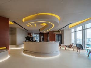 Modern open concept living space with a bar counter, chairs, and a dining table, featuring a focus on functionality and comfort