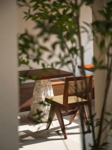 Cozy dining space with two wooden chairs and benches, warm and inviting atmosphere, wood as primary material