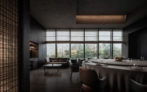 Sophisticated dining space with a large wooden table, high-quality furniture, and artwork on the walls