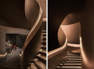 A wooden staircase with a curved spiral design and a straight flight view, showcasing its unique features and intricate details