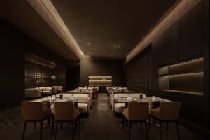 Elegant restaurant interior with wooden floors, white tablecloths, and comfortable seating areas
