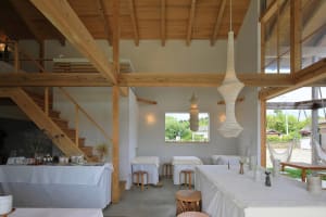 Open living and dining area with wooden floors, white walls, and a warm atmosphere