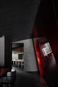 A restaurant dining area with multiple tables and chairs, creating an inviting atmosphere for guests to enjoy a meal in a social setting