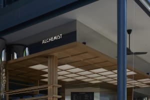 A storefront with a wooden exterior, showcasing books in the window and inviting atmosphere