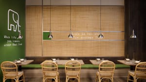 A warm and inviting dining area with multiple tables and chairs, soft lighting, and a cozy atmosphere