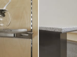 A modern kitchen with a grey marble countertop and a wooden cabinet with a silver handle