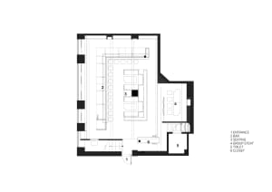 Black and white architectural drawing of a large open interior space with various rooms and spaces, including a kitchen and dining area