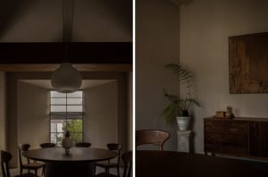 Dimly lit dining space with chairs, a dining table, and a potted plant near a window